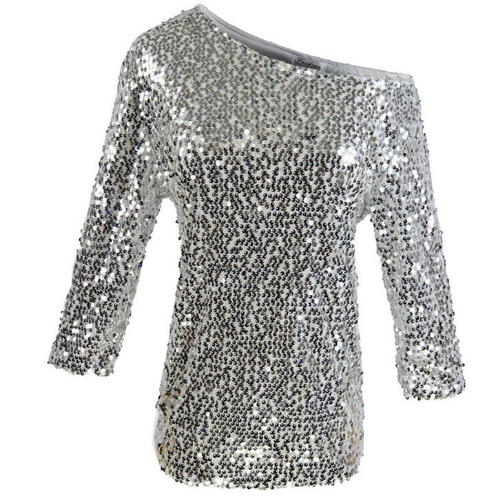 Kvinders glitrende top med off-shoulder design og paliettrim.