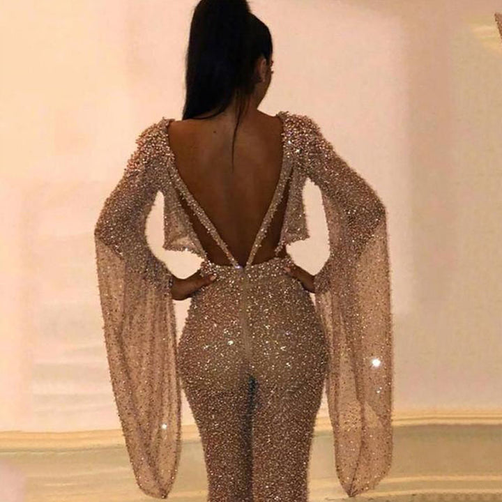 Dame Glitrende Jumpsuit med dyb ryg og flydende ærmer Stilla