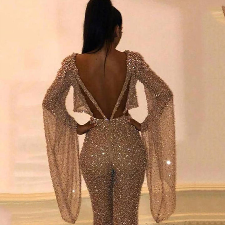 Dame Glitrende Jumpsuit med dyb ryg og flydende ærmer Stilla