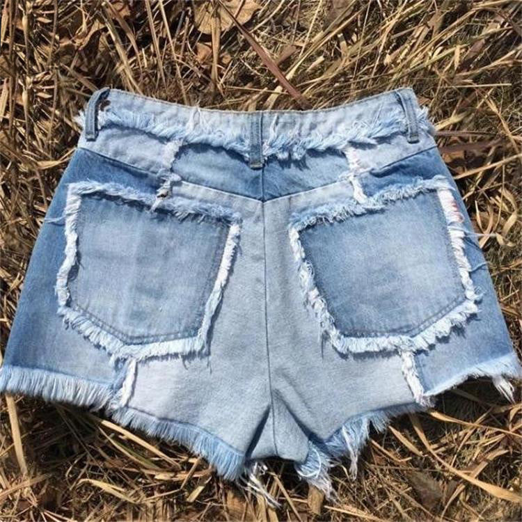 Dame moderigtige Denim-shorts i patchwork-design med frynset afslutning og høj talje Stilla