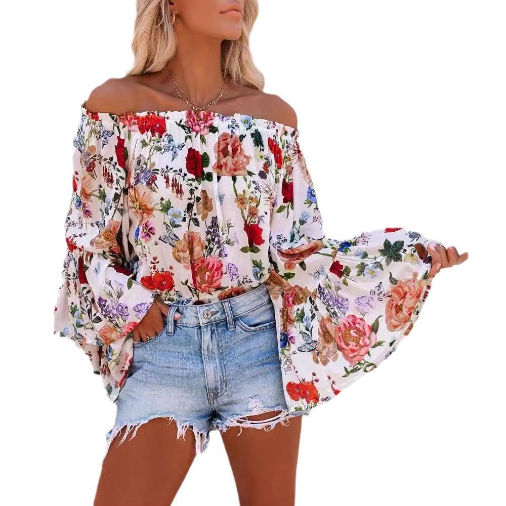 Dame Off-Shoulder Bluse med voluminøse ærmer og florale accenter Stilla