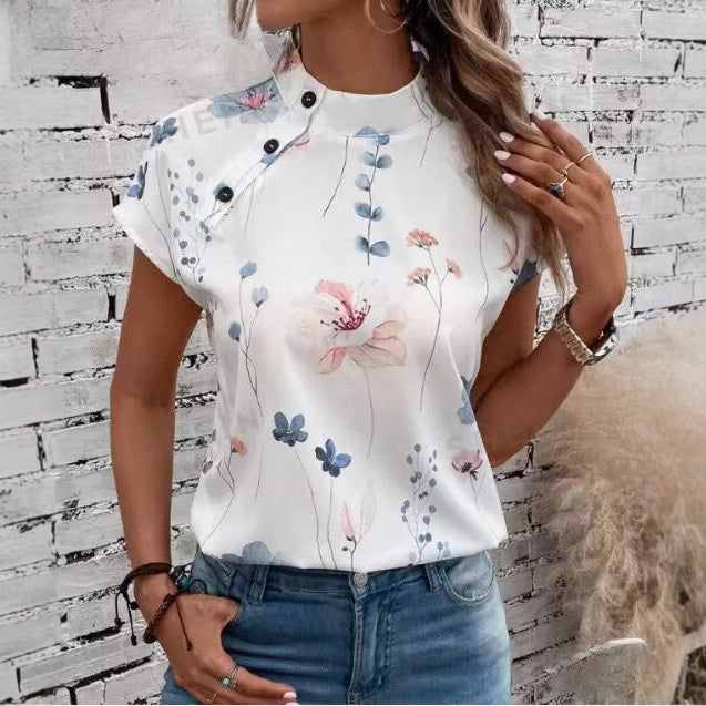 Damebluse med blomsterdesign og capærmer Stilla