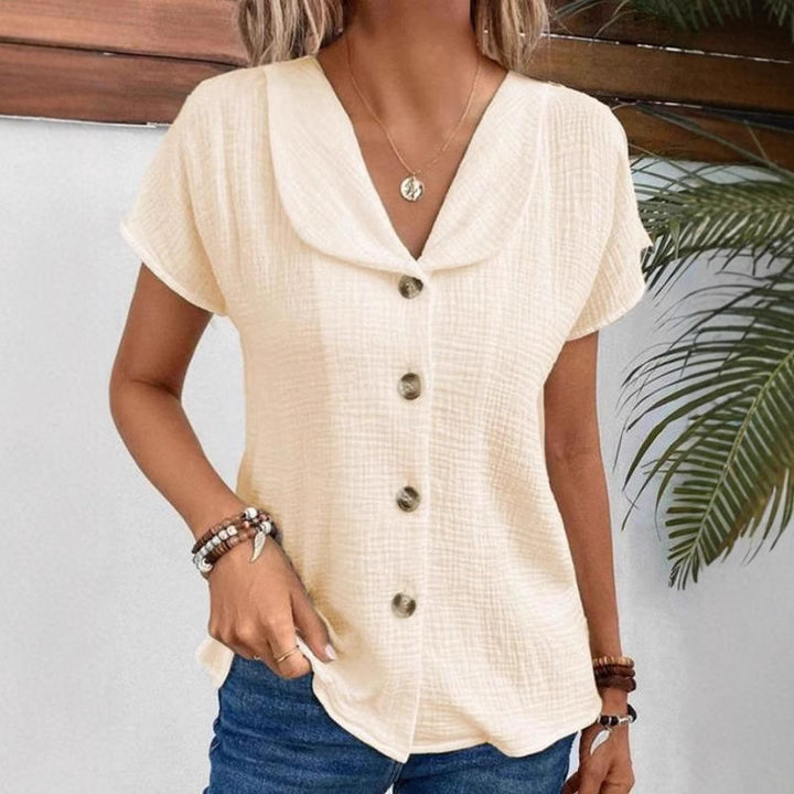 Damebluse med elegant klapkrave og dekorative knapper Stilla