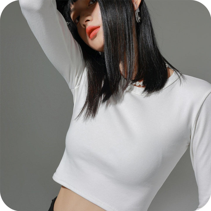 Dame figursyet langærmet crop-top i elastisk materiale med hudvenligt feel Stilla