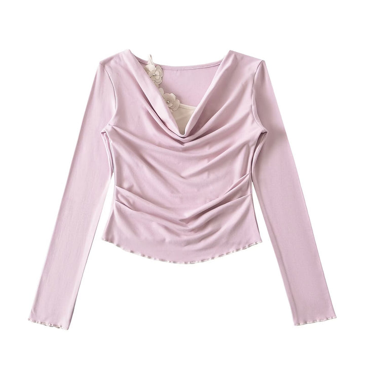 Dame elegant langærmet top med raffinerede draperingsdetaljer og blomsterakcent Stilla