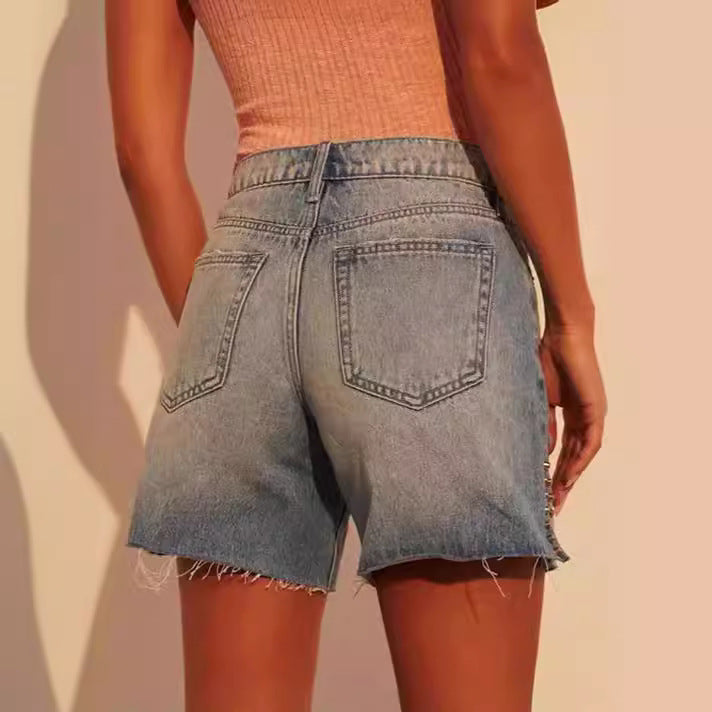 Dame Elegante Denim-Shorts med trendy Ripped-detaljer og dekorative trykknapper Stilla