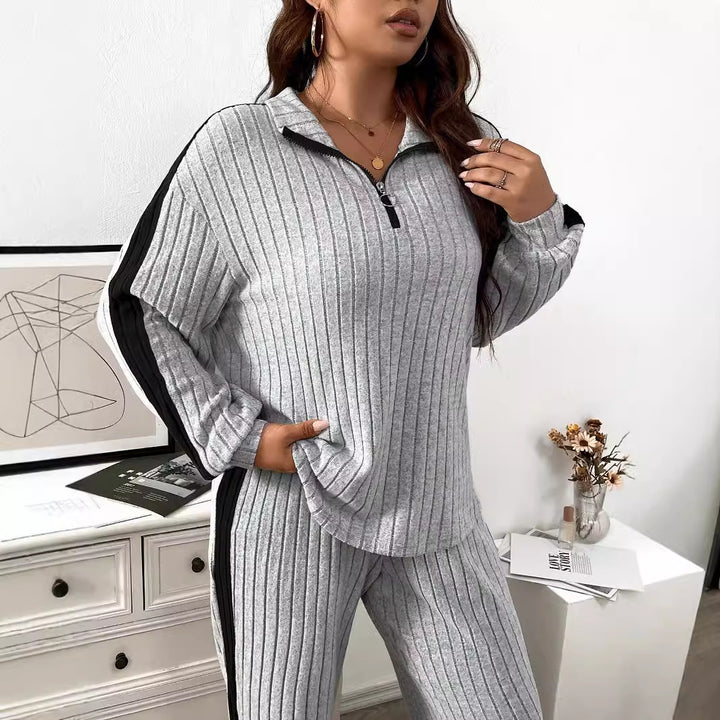 Dame elegant sportdragt med lynlås og stribet design Stilla