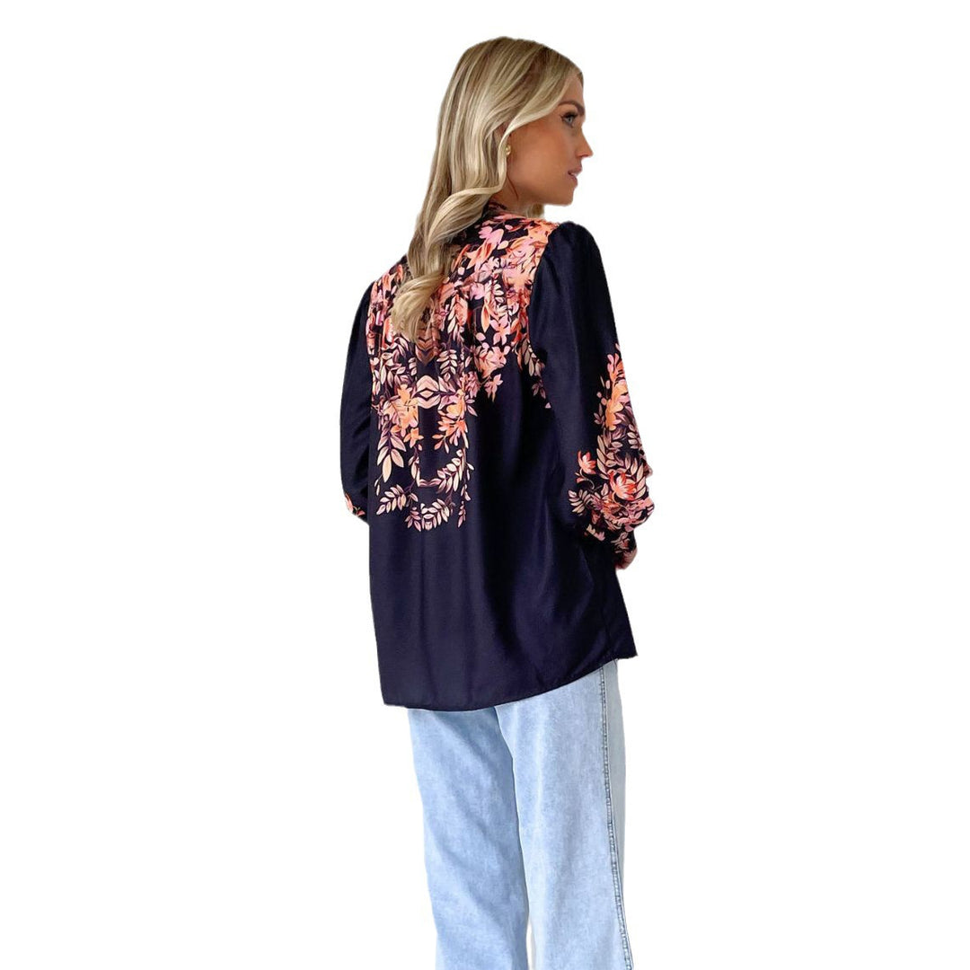Dame elegant bluse med blomsteraccenter og moderne puffærmer