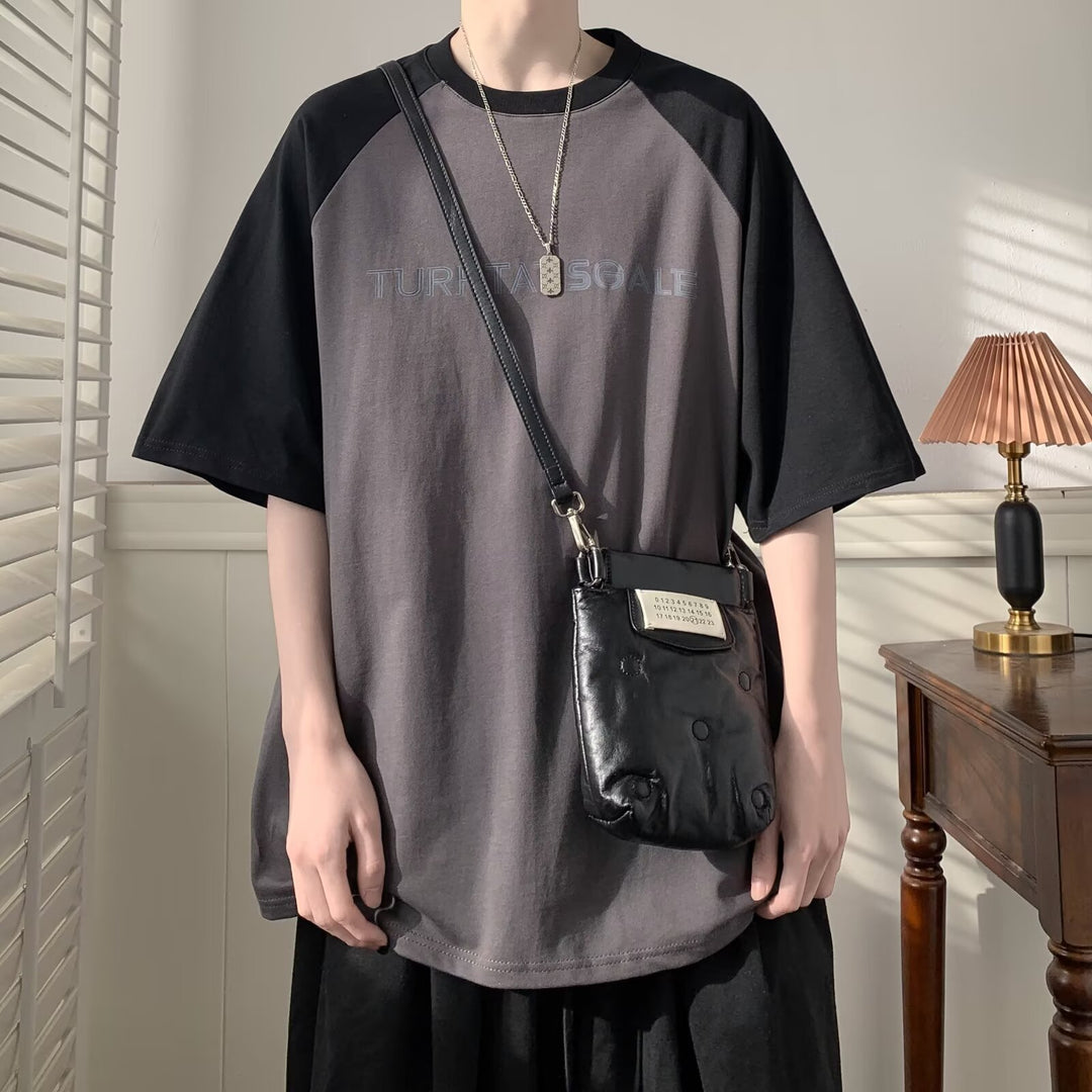 Unisex Oversized T-Shirt med asymmetrisk design og kreativ tekst Stilla
