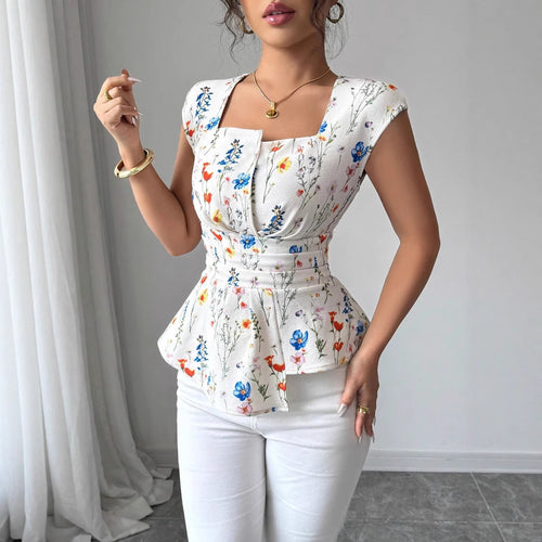 Damebluse med tætsiddende peplum-silhuet og blomsterdesign Stilla