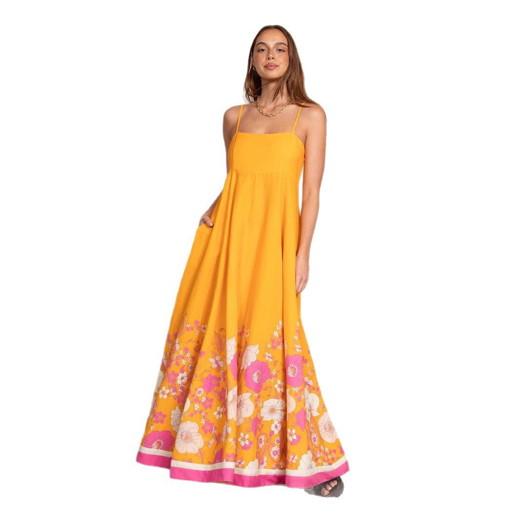 Dame maxikjole med floralt design og elegante spaghetti-stropper Skovae