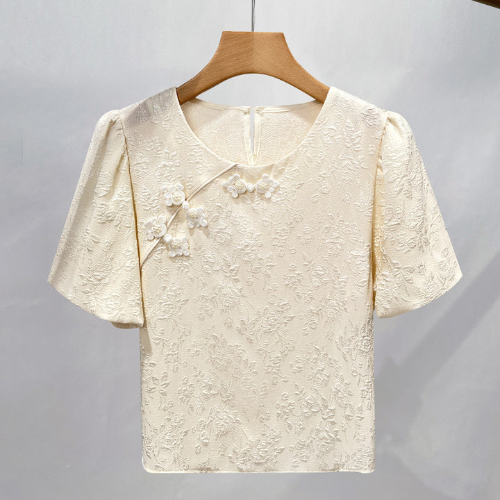Damebluse med blomsterreliefmønster og dekorative perle-detaljer Stilla