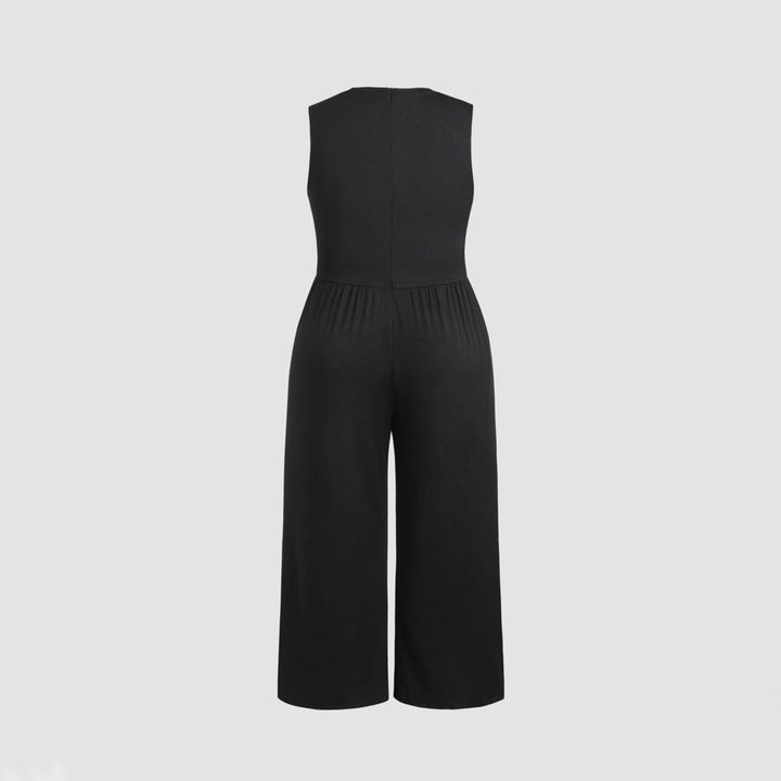 Dame jumpsuit med elegant off-shoulder design og praktiske sidelommer Skovae