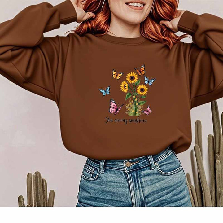 Damebluse med blomstermotiv og motiverende print Stilla