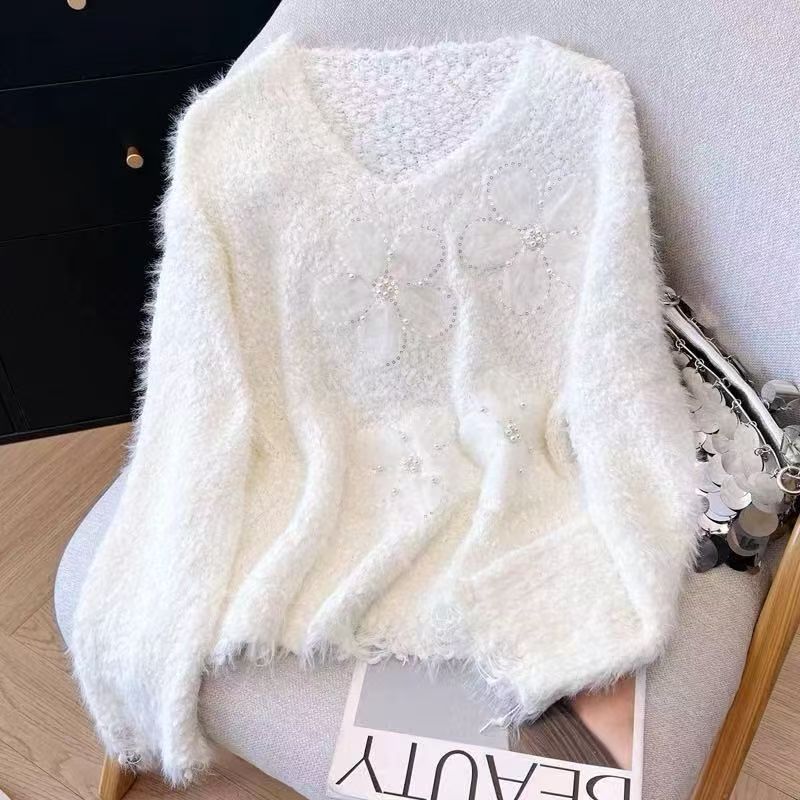 Kvindernes hyggelige sweater med blomsterapplikationer Stilla