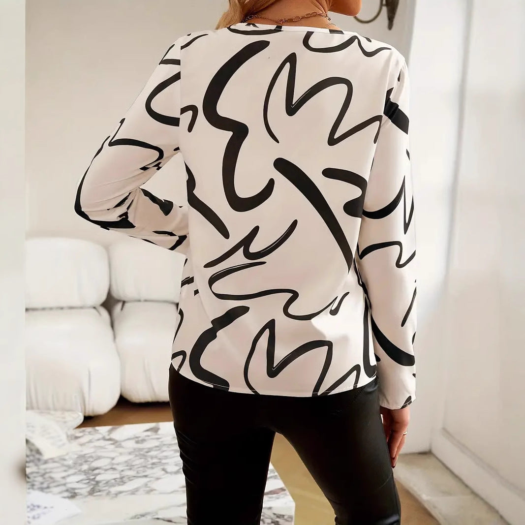 Damebluse med moderne abstrakt design og elegante knapdetaljer Stilla