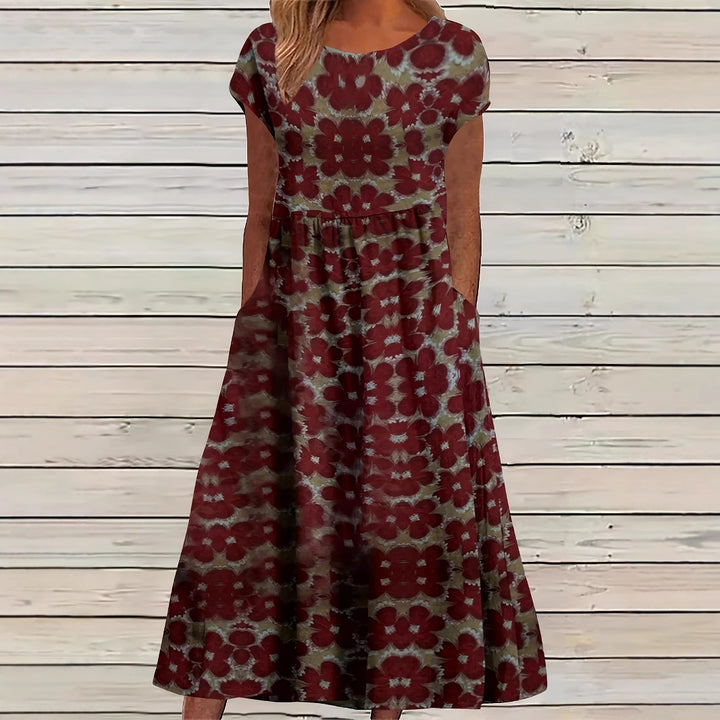 Dame Maxikjole med legende blomsterdesign og praktiske sidelommer Stilla