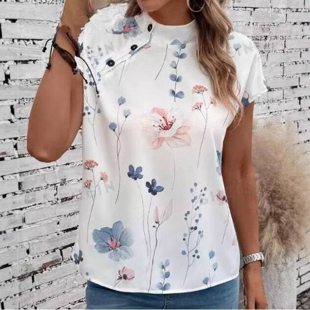Damebluse med blomsterdesign og capærmer Stilla