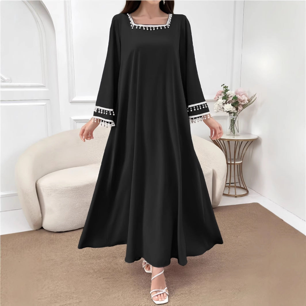 Kvinders elegante maxi kjole med dekorative frynser og brede ærmer Skovae