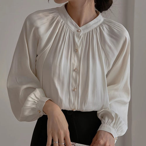 Damebluse med elegant perleknapdesign og flatterende pasform Stilla