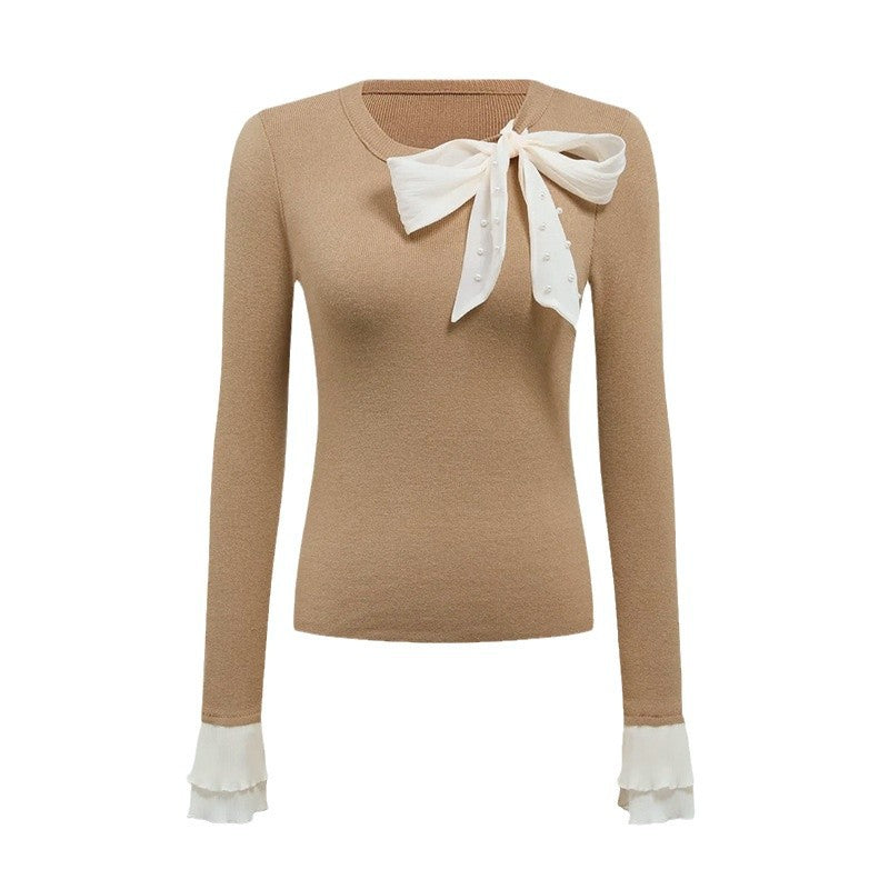 Kvinders elegante top med chic bueapplikation Stilla