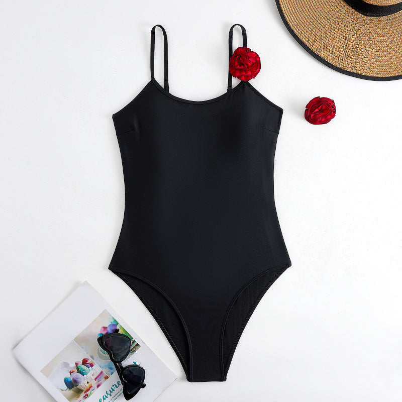 Dame one-piece badedragt med dekorative blomsterapplikationer og elegant indpakningsskørtek Skovae