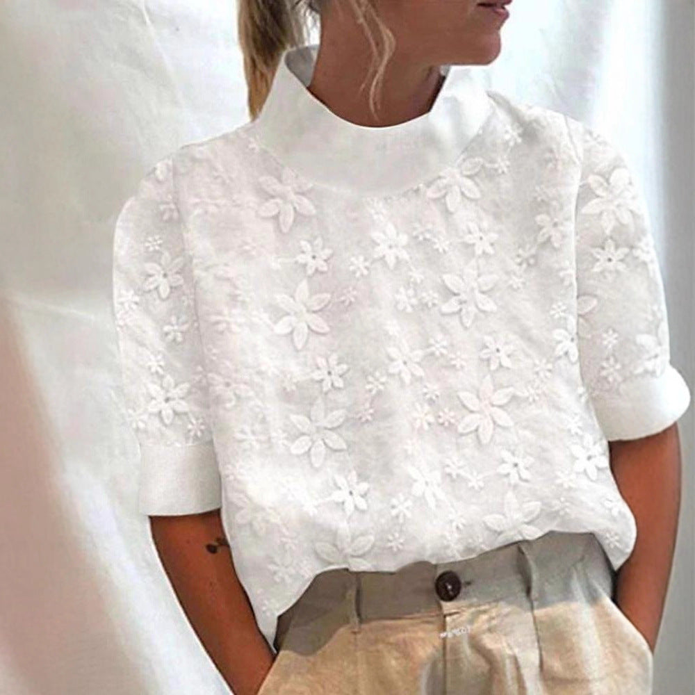 Kvinders bluse med blomsterbroderi design og kort snit Stilla