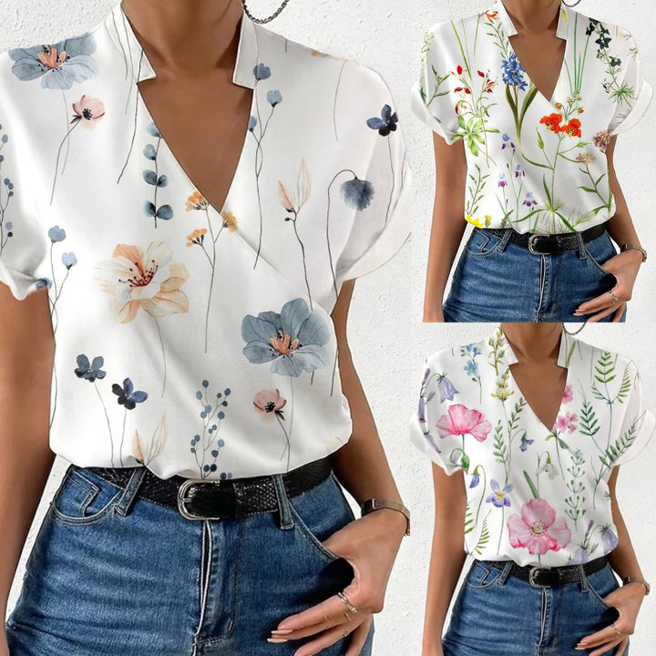 Damebluse med floralt design og moderne V-udskæring Stilla