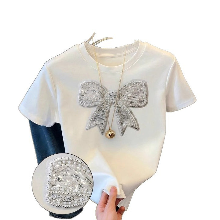 Dame T-shirt med glitrende sløjfemotiv og fin broderiteknik Skovae