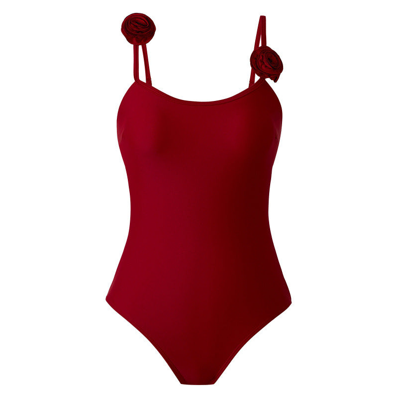 Dame one-piece badedragt med dekorative blomsterapplikationer og elegant indpakningsskørtek Skovae