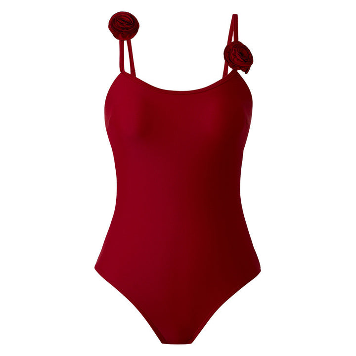 Dame one-piece badedragt med dekorative blomsterapplikationer og elegant indpakningsskørtek Skovae