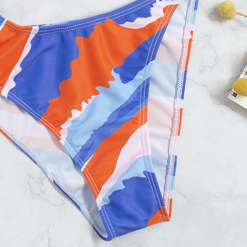 Dame one-piece badedragt med asymmetrisk snit og guldfarvede accenter Skovae