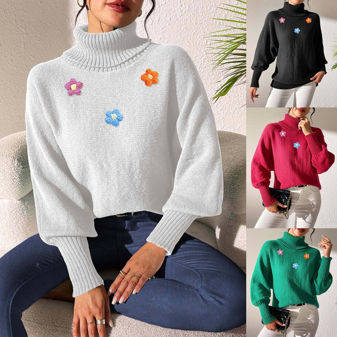 Dame moderigtigt strikpullover med høj krave og farverige blomsterapplikationer Stilla