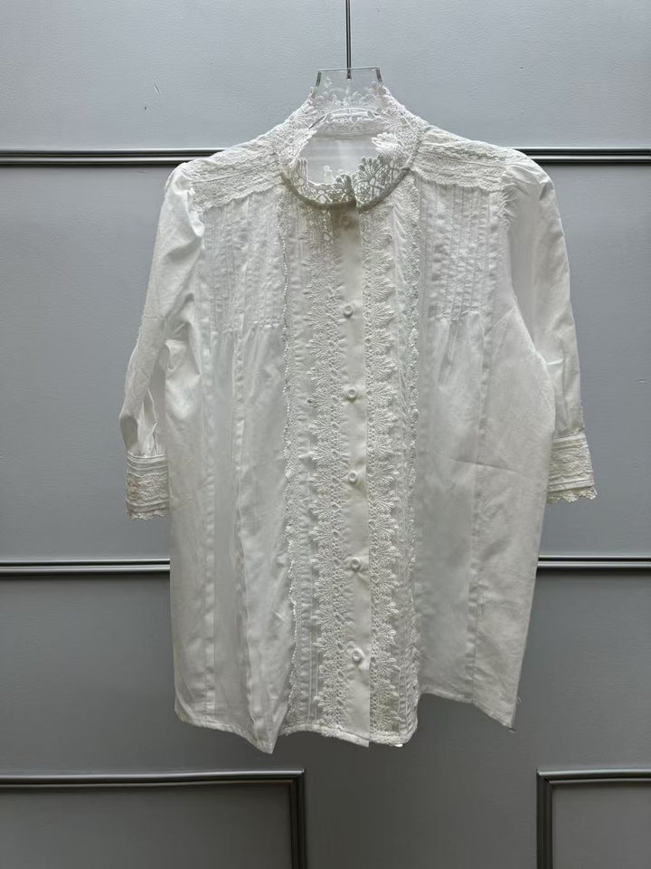 Damebluse med filigrane spidsdetaljer og dekorative knapper Stilla