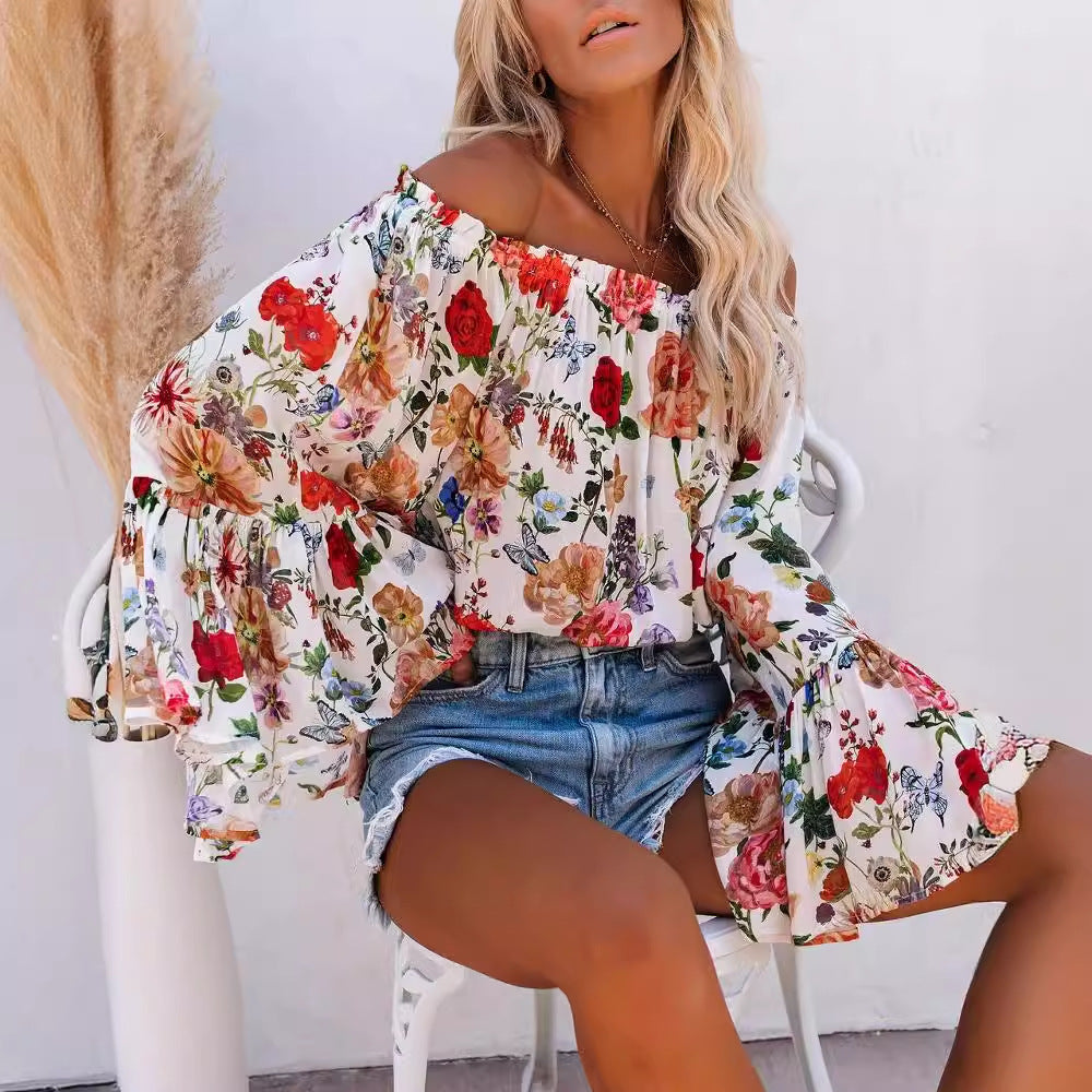 Dame Off-Shoulder Bluse med voluminøse ærmer og florale accenter Stilla