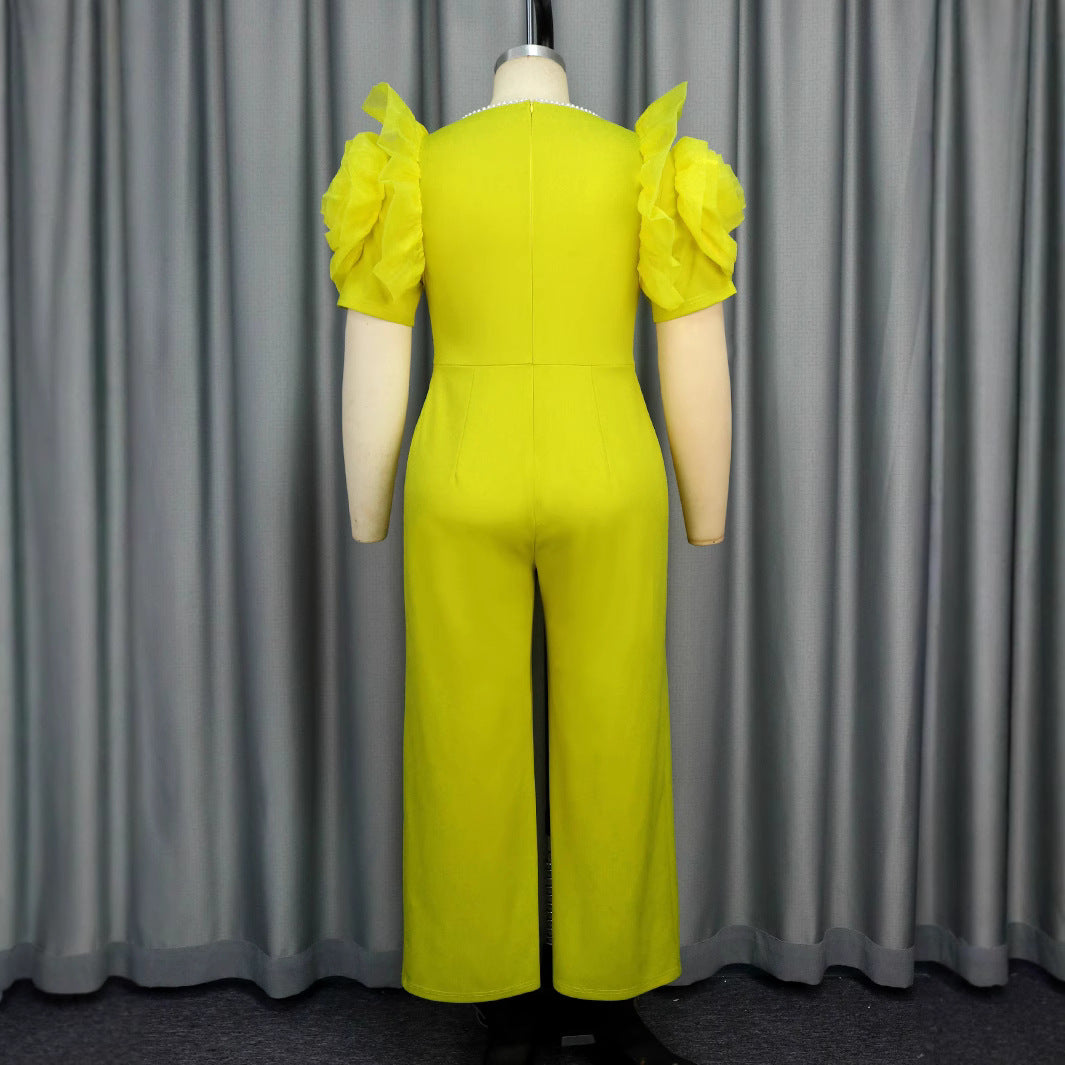 Dame elegant jumpsuit med voluminøse puffærmer og perleaccent Skovae