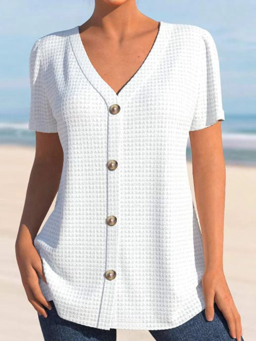 Dame kortærmet bluse med elegant knaplukning og struktureret design Stilla