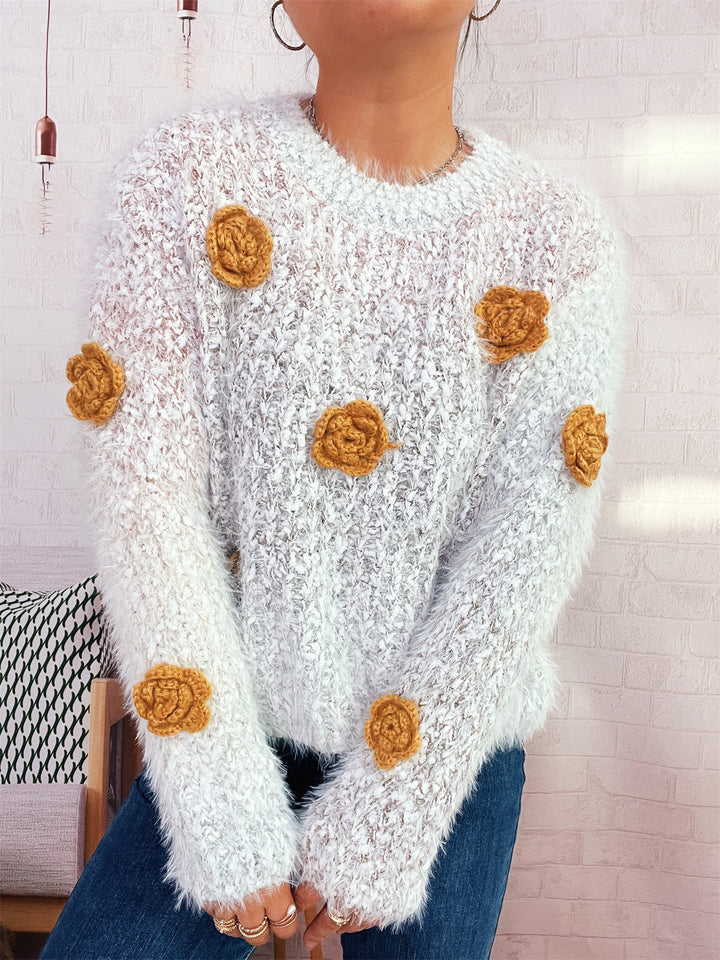 Kvindernes hyggelige strikket sweater med blomsterdetalje Stilla