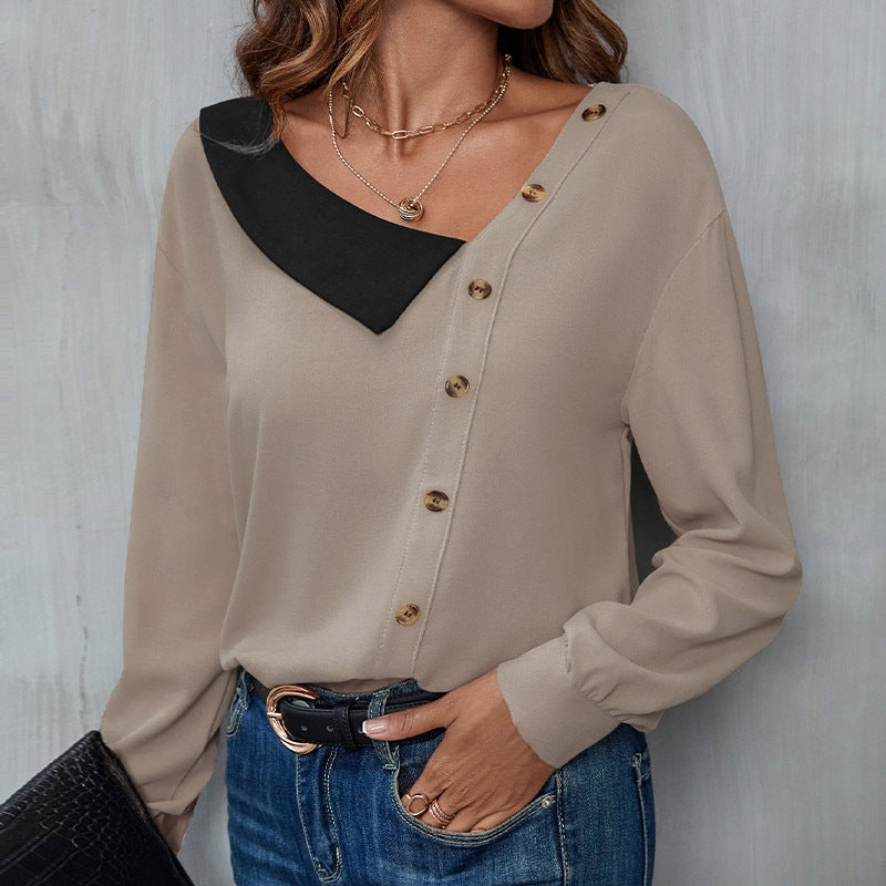Damebluse med asymmetrisk krave og dekorative knapdetaljer Stilla