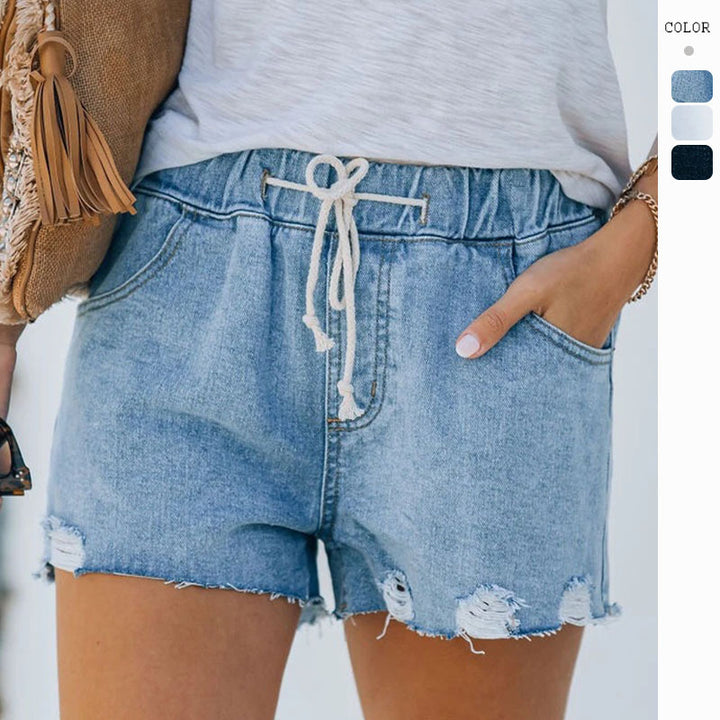 Dame vintage denim shorts med elastisk talje og trendy slidte detaljer