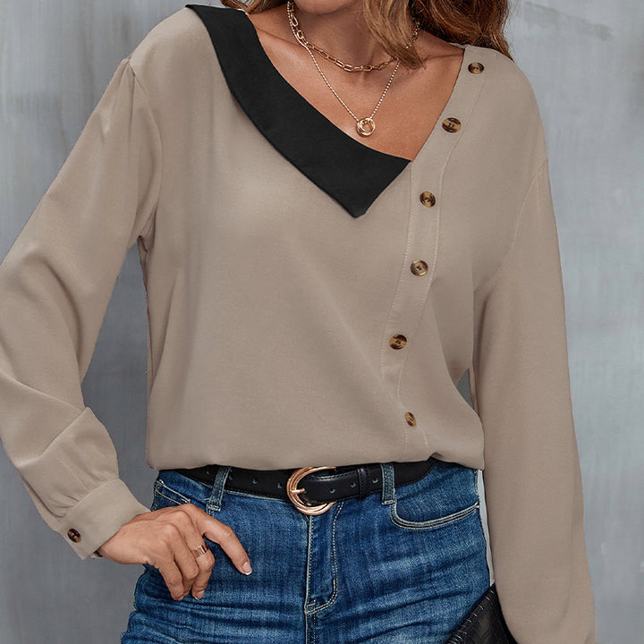 Damebluse med asymmetrisk krave og dekorative knapdetaljer Stilla