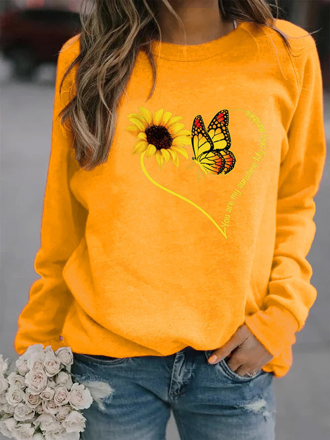 Kvinders sweatshirt med grafisk sommerfugl og solskinsmotiv Stilla