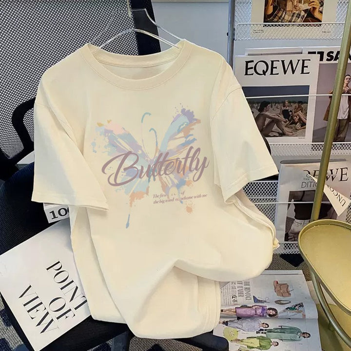 Dame T-shirt med kunstnerisk sommerfugletryk og inspirerende tekst Stilla