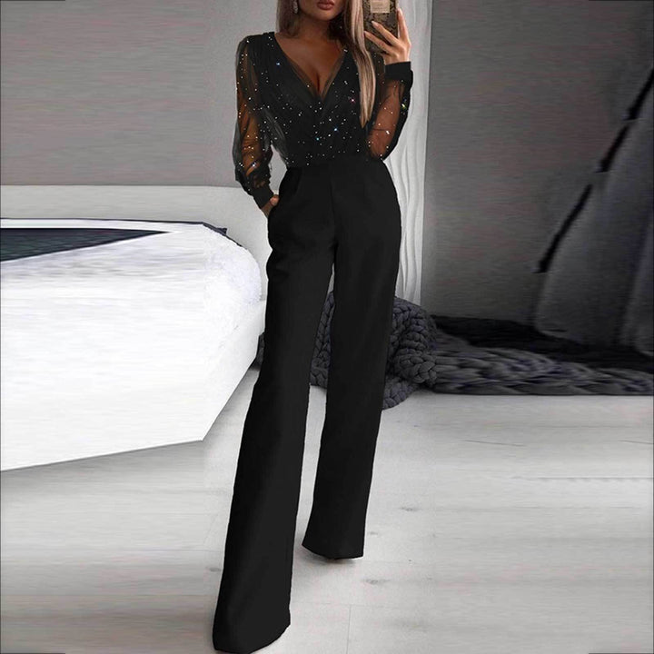 Damernes elegante jumpsuit med transparente ærmer og glitrende detaljer Skovae