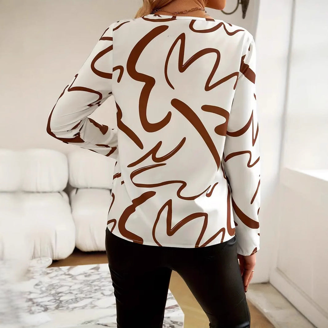 Damebluse med moderne abstrakt design og elegante knapdetaljer Stilla
