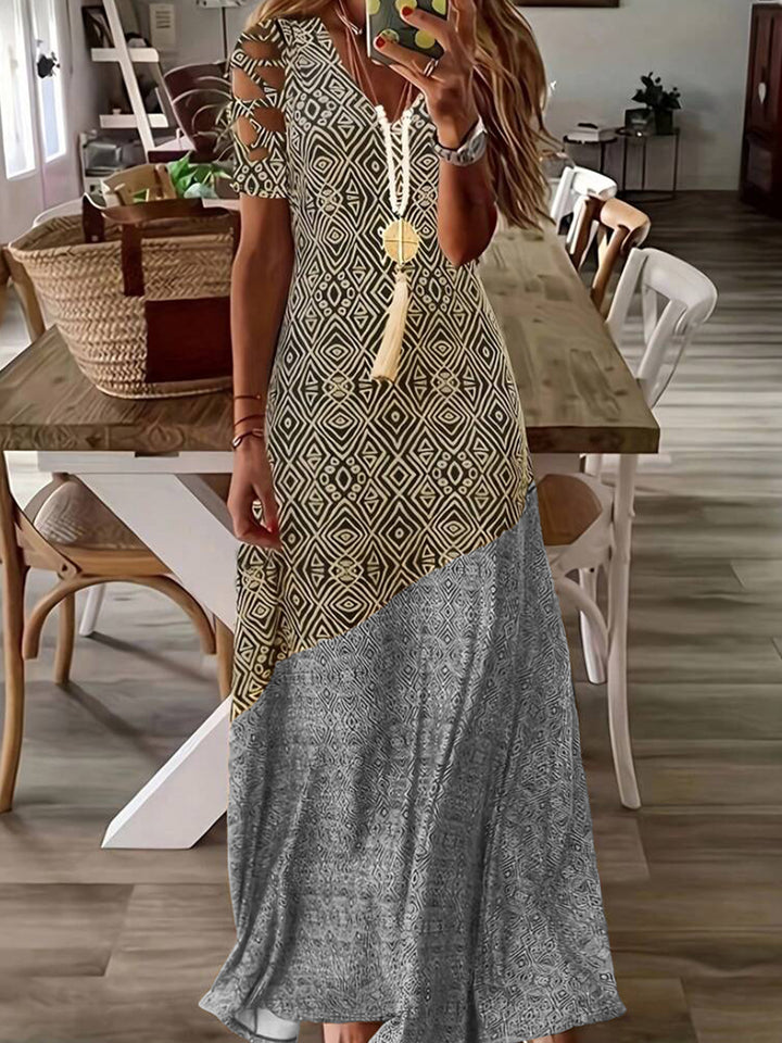 Dame Maxikjole med asymmetrisk snit og moderne cut-out-detaljer Stilla