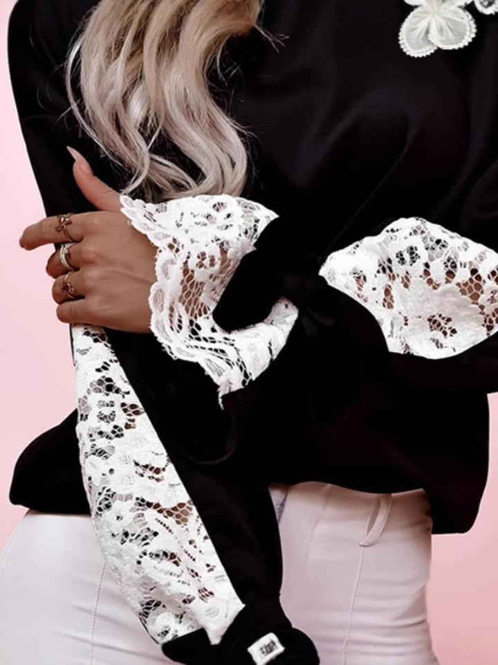 Dame top med elegante spids ærmer og fashionable detaljer Stilla