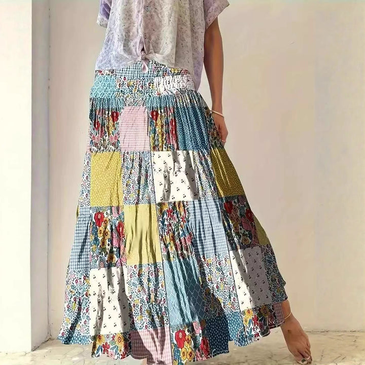 Dame maxikirtel i patchwork-design med elastisk talje og flydende snit Stilla