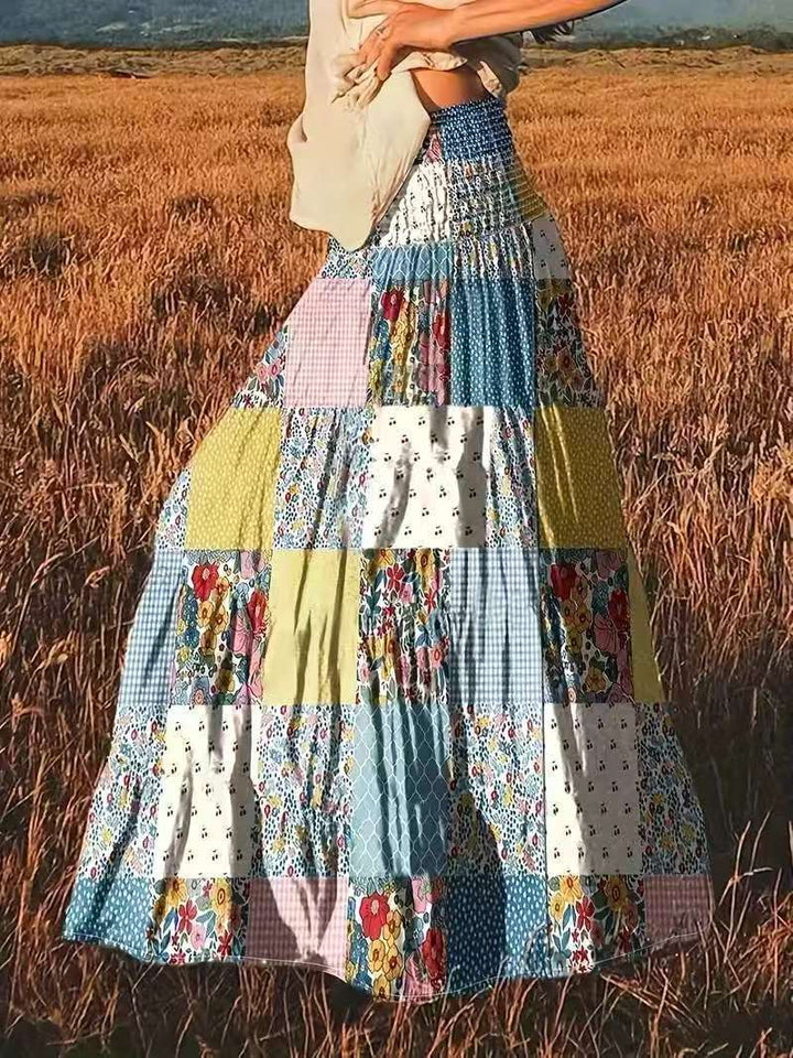 Dame maxikirtel i patchwork-design med elastisk talje og flydende snit Stilla