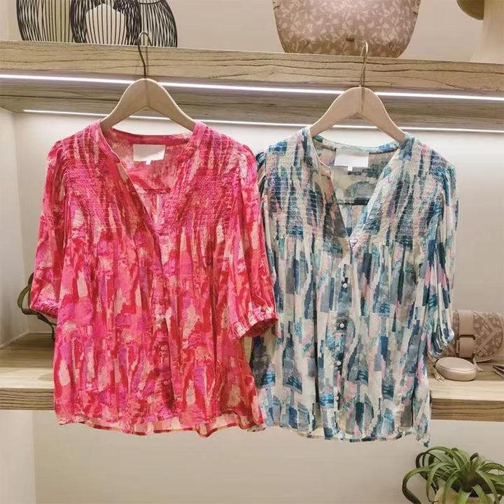 Damebluse med voluminøse puffærmer og raffineret smockdesign Stilla
